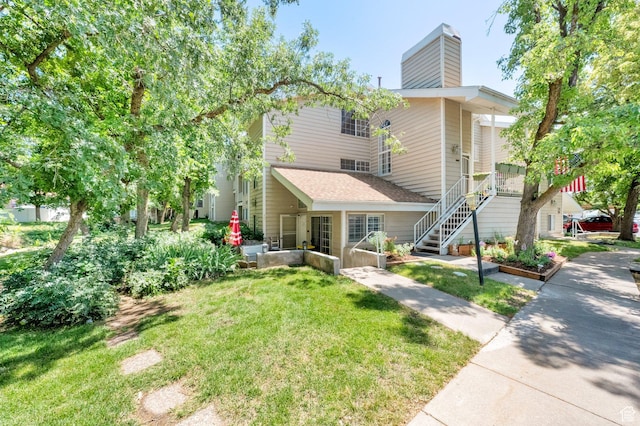 650 S Main St Unit 7103, Bountiful, UT 84010 - view of front of house with a front lawn, a chimney, and stairs