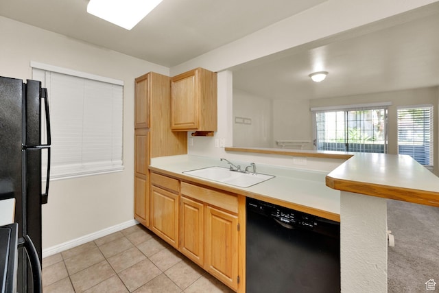 650 S Main St Unit 7103, Bountiful, UT 84010 - kitchen with black appliances, a peninsula, light countertops, light tile patterned floors, and light brown cabinetry