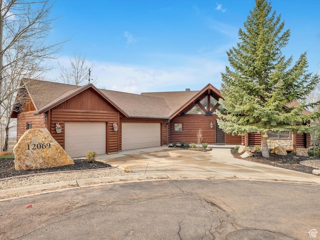 12069 N Sage Hollow Cir, Heber City, UT 84032 - log cabin with a shingled roof, an attached garage, driveway, stone siding, and log veneer siding