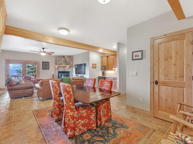 12069 N Sage Hollow Cir, Heber City, UT 84032 - dining room featuring stone tile flooring, beamed ceiling, ceiling fan, and a fireplace