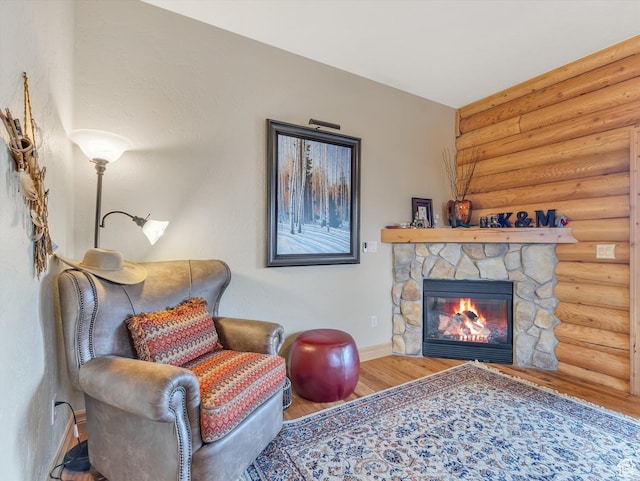 12069 N Sage Hollow Cir, Heber City, UT 84032 - sitting room featuring rustic walls, wood finished floors, and a fireplace