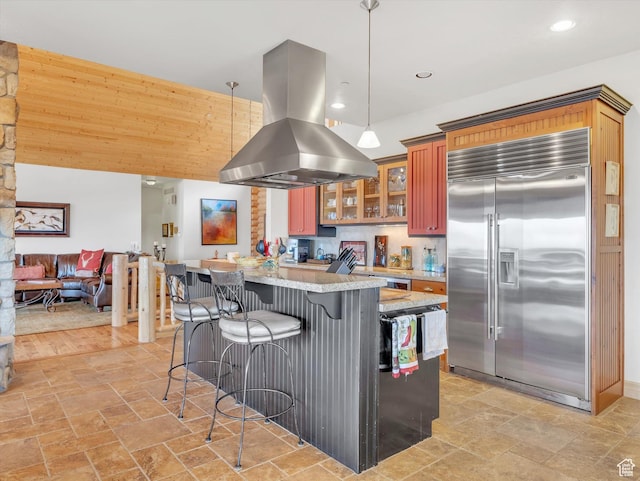 12069 N Sage Hollow Cir, Heber City, UT 84032 - kitchen with stainless steel built in refrigerator, island exhaust hood, stone tile floors, a breakfast bar area, and recessed lighting