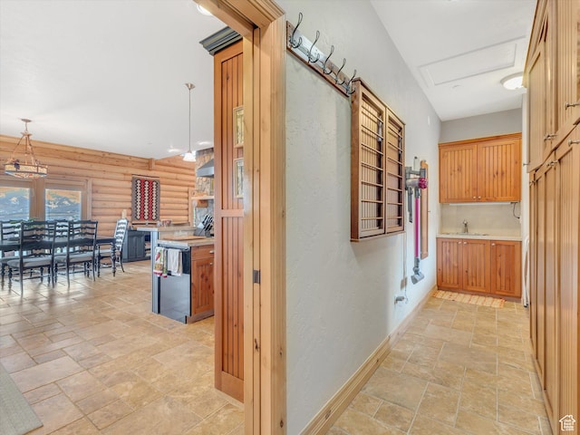 12069 N Sage Hollow Cir, Heber City, UT 84032 - hallway featuring stone tile floors, log walls, and a textured wall