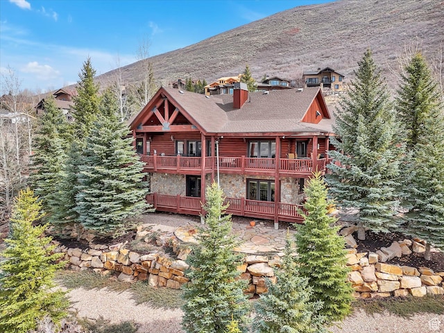 12069 N Sage Hollow Cir, Heber City, UT 84032 - rear view of property with stone siding, a balcony, french doors, and a deck with mountain view