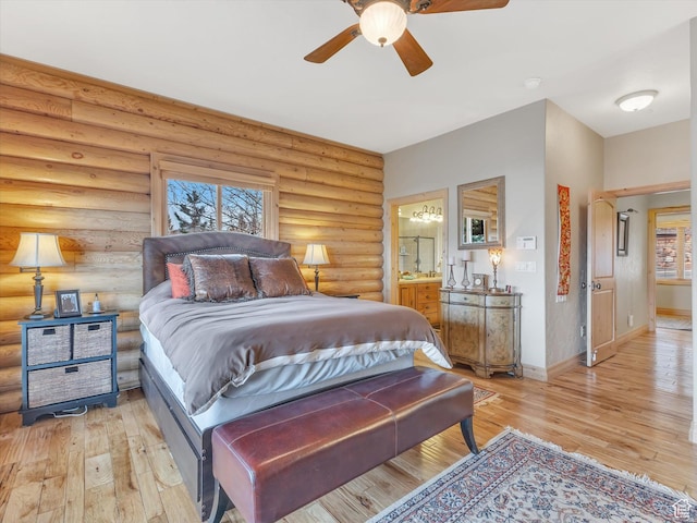 12069 N Sage Hollow Cir, Heber City, UT 84032 - bedroom featuring light wood-style floors, ensuite bathroom, rustic walls, and a ceiling fan