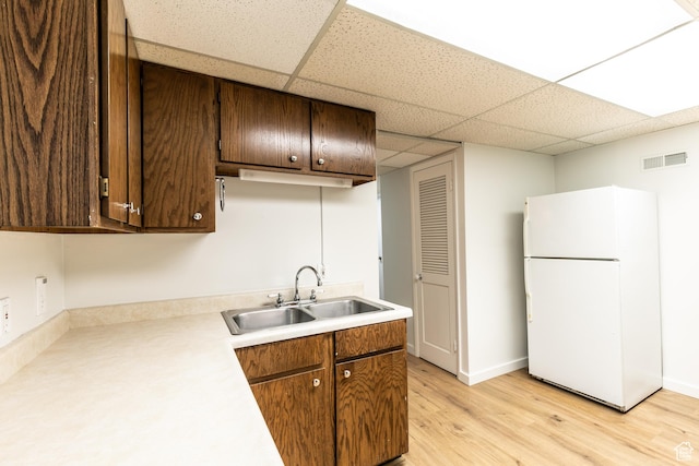 1723 E 2100 S, Salt Lake City, UT 84106 - kitchen with freestanding refrigerator, a paneled ceiling, light countertops, light wood finished floors, and dark brown cabinets