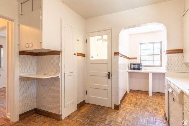 1723 E 2100 S, Salt Lake City, UT 84106 - kitchen with white dishwasher, light countertops, backsplash, and arched walkways