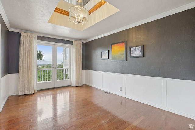 1174 Oakmont Ln, Provo, UT 84604 - empty room featuring french doors, a chandelier, wood finished floors, crown molding, and wainscoting