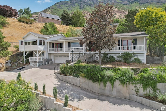 1174 Oakmont Ln, Provo, UT 84604 - view of front of property with stairs, an attached garage, covered porch, concrete driveway, and a mountain view
