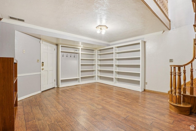1174 Oakmont Ln, Provo, UT 84604 - empty room with a textured ceiling, crown molding, hardwood / wood-style flooring, stairway, and built in shelves