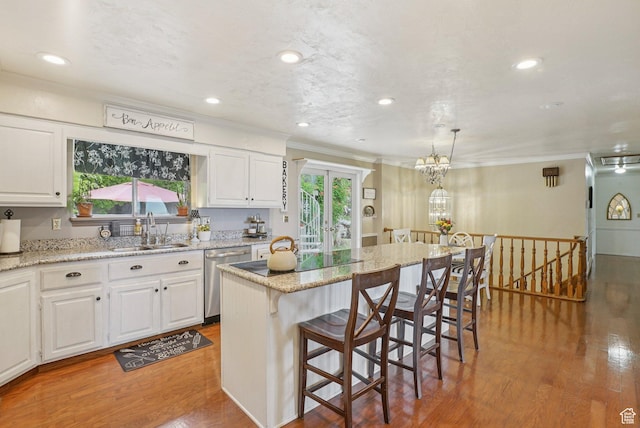 1174 Oakmont Ln, Provo, UT 84604 - kitchen featuring dishwasher, crown molding, light wood-type flooring, a breakfast bar, and white cabinets