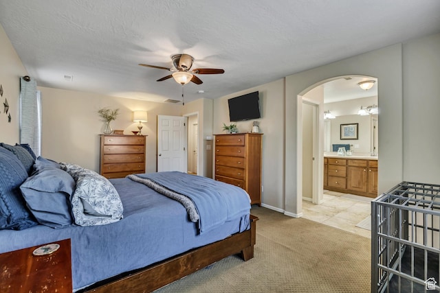 10253 S Clarks Hill Dr, South Jordan, UT 84009 - bedroom with arched walkways, light carpet, a ceiling fan, and connected bathroom