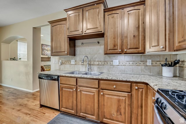 10253 S Clarks Hill Dr, South Jordan, UT 84009 - kitchen with stainless steel appliances, light wood-style floors, backsplash, light stone countertops, and brown cabinetry