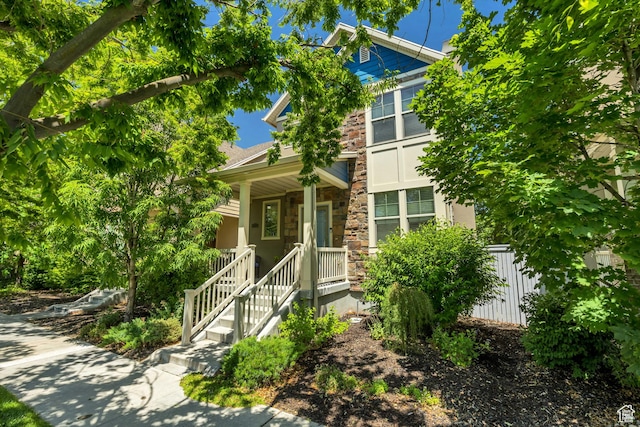 10253 S Clarks Hill Dr, South Jordan, UT 84009 - view of property hidden behind natural elements featuring stone siding and a porch