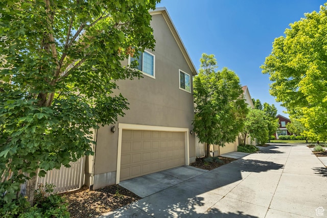 10253 S Clarks Hill Dr, South Jordan, UT 84009 - view of home's exterior with a garage, stucco siding, and driveway