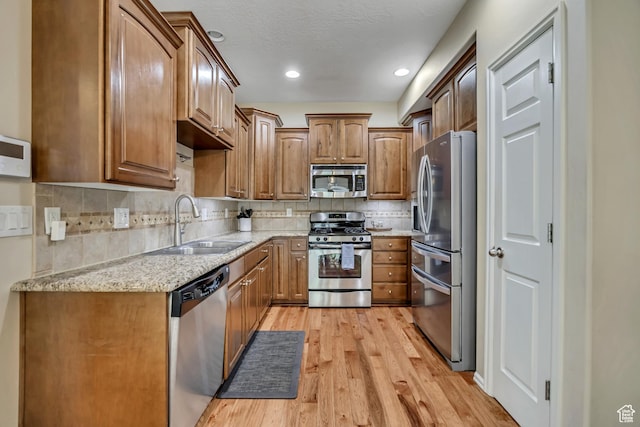 10253 S Clarks Hill Dr, South Jordan, UT 84009 - kitchen with stainless steel appliances, light wood-style floors, tasteful backsplash, light stone counters, and recessed lighting