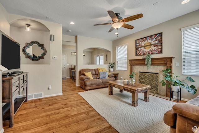 10253 S Clarks Hill Dr, South Jordan, UT 84009 - living room with ceiling fan, light wood-style floors, a high end fireplace, plenty of natural light, and recessed lighting