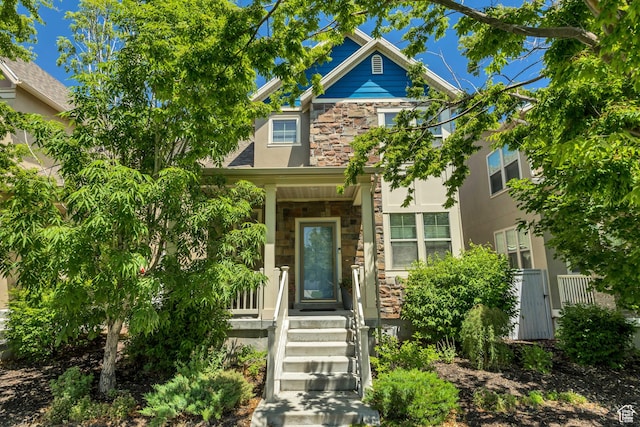 10253 S Clarks Hill Dr, South Jordan, UT 84009 - view of front of property with stone siding, stucco siding, and a porch