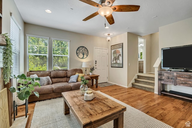 10253 S Clarks Hill Dr, South Jordan, UT 84009 - living room with plenty of natural light, a ceiling fan, light wood-style floors, stairway, and recessed lighting