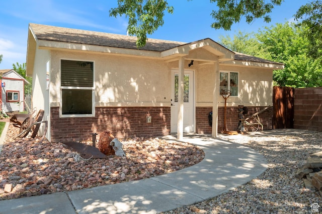320 S 460 W, Hurricane, UT 84737 - view of front of property featuring brick siding, stucco siding, and roof with shingles