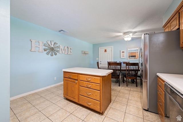 320 S 460 W, Hurricane, UT 84737 - kitchen featuring stainless steel appliances, brown cabinetry, light tile patterned flooring, and light countertops