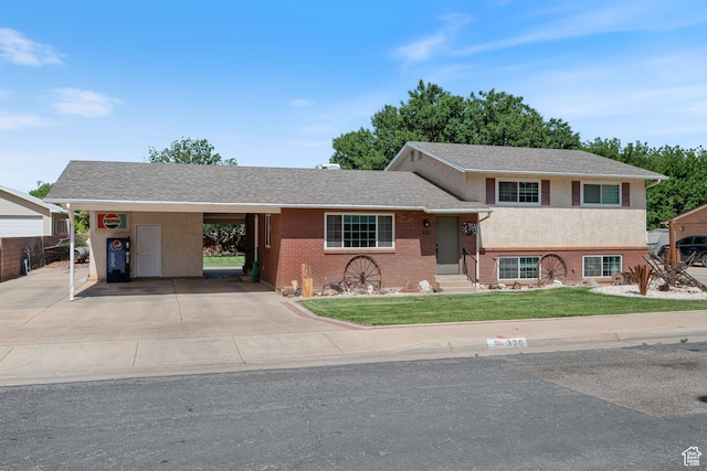 320 S 460 W, Hurricane, UT 84737 - view of front of home featuring entry steps, a front yard, an attached carport, driveway, and brick siding