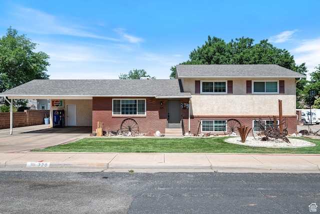 320 S 460 W, Hurricane, UT 84737 - view of front of home with concrete driveway, a carport, brick siding, entry steps, and stucco siding