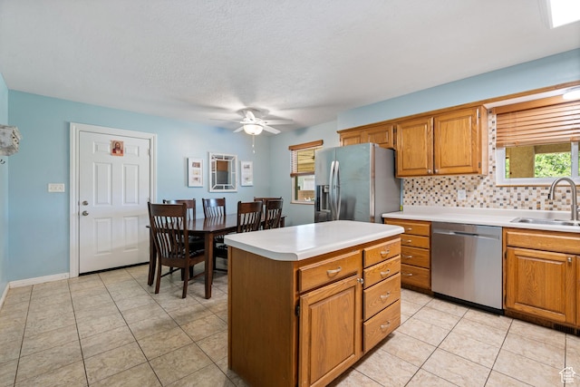 320 S 460 W, Hurricane, UT 84737 - kitchen featuring appliances with stainless steel finishes, tasteful backsplash, light countertops, ceiling fan, and brown cabinetry
