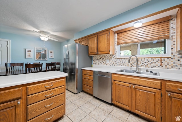 320 S 460 W, Hurricane, UT 84737 - kitchen with stainless steel appliances, brown cabinetry, decorative backsplash, light countertops, and a textured ceiling