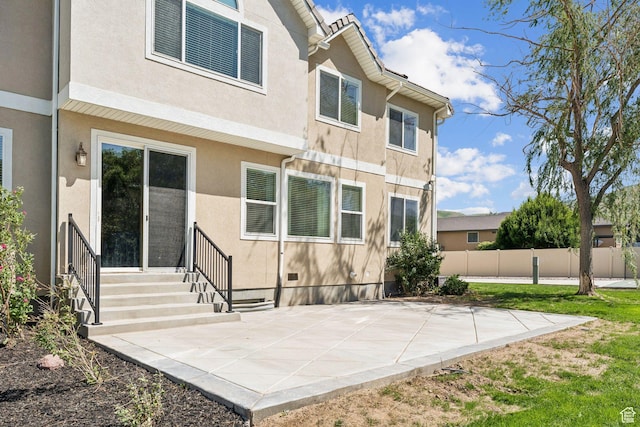 14318 S Butterfield Park Way, Herriman, UT 84096 - back of property with a patio and stucco siding