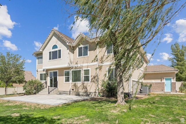 14318 S Butterfield Park Way, Herriman, UT 84096 - back of house with a patio area, stucco siding, and entry steps