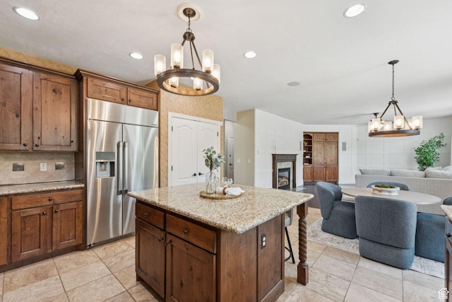 14318 S Butterfield Park Way, Herriman, UT 84096 - kitchen with built in fridge, a chandelier, open floor plan, pendant lighting, and recessed lighting