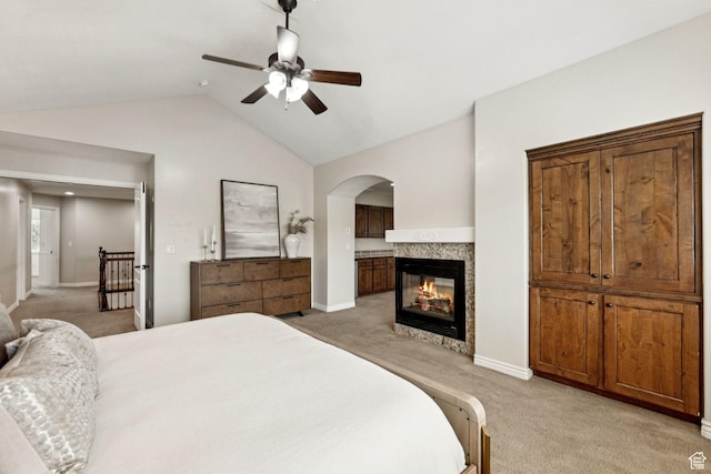 14318 S Butterfield Park Way, Herriman, UT 84096 - bedroom featuring light colored carpet, vaulted ceiling, arched walkways, a multi sided fireplace, and a ceiling fan