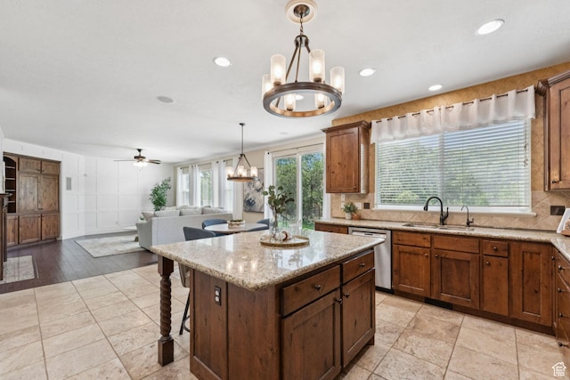 14318 S Butterfield Park Way, Herriman, UT 84096 - kitchen featuring dishwasher, a chandelier, pendant lighting, tasteful backsplash, and a center island