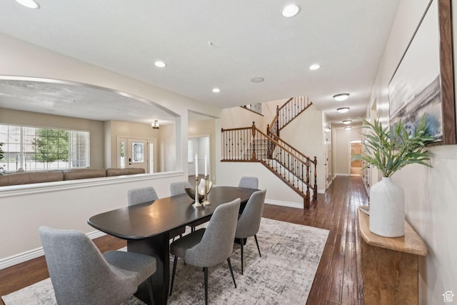 14318 S Butterfield Park Way, Herriman, UT 84096 - dining space featuring arched walkways, stairway, dark wood-style floors, and recessed lighting