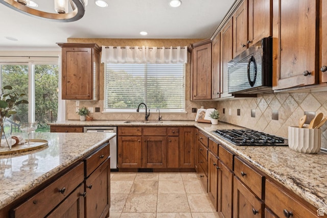 14318 S Butterfield Park Way, Herriman, UT 84096 - kitchen with black microwave, gas stovetop, dishwasher, plenty of natural light, and recessed lighting