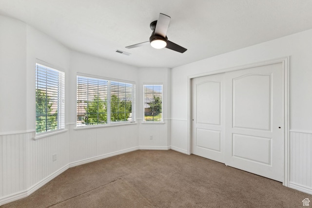 14318 S Butterfield Park Way, Herriman, UT 84096 - unfurnished bedroom with carpet, a closet, ceiling fan, and a wainscoted wall