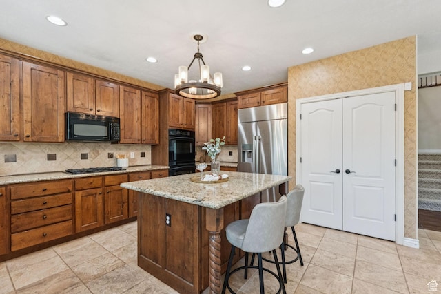 14318 S Butterfield Park Way, Herriman, UT 84096 - kitchen with black appliances, brown cabinetry, a center island, a breakfast bar, and a chandelier