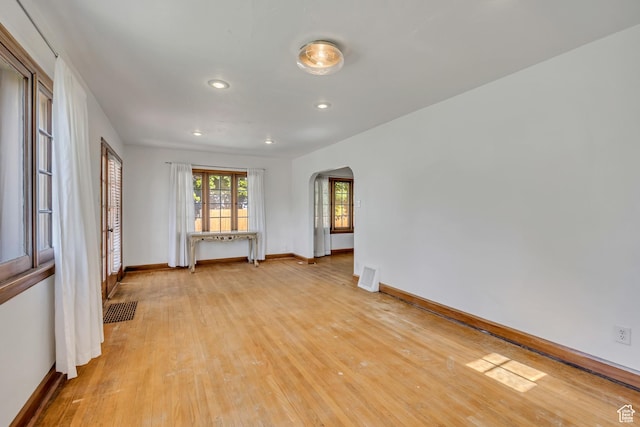 1252 E Bryan Ave S, Salt Lake City, UT 84105 - unfurnished room with arched walkways, light wood-style floors, and recessed lighting