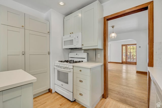 1252 E Bryan Ave S, Salt Lake City, UT 84105 - kitchen with white appliances, light wood finished floors, light countertops, recessed lighting, and arched walkways