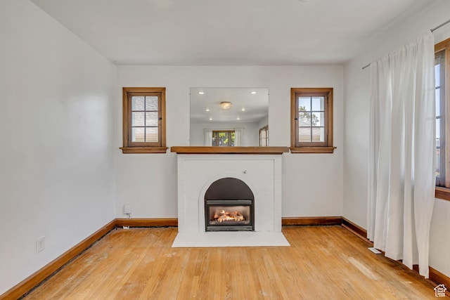 1252 E Bryan Ave S, Salt Lake City, UT 84105 - unfurnished living room with wood-type flooring, a brick fireplace, and recessed lighting
