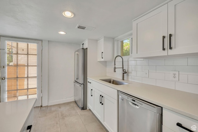 1252 E Bryan Ave S, Salt Lake City, UT 84105 - kitchen featuring appliances with stainless steel finishes, backsplash, light countertops, white cabinetry, and recessed lighting