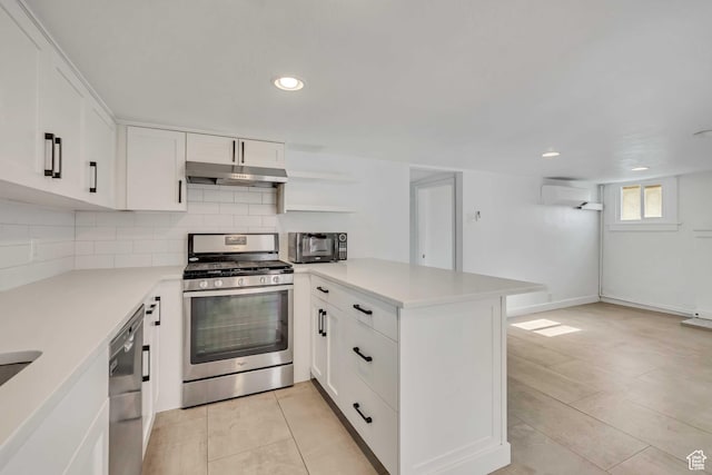 1252 E Bryan Ave S, Salt Lake City, UT 84105 - kitchen featuring stainless steel appliances, under cabinet range hood, a peninsula, light countertops, and recessed lighting