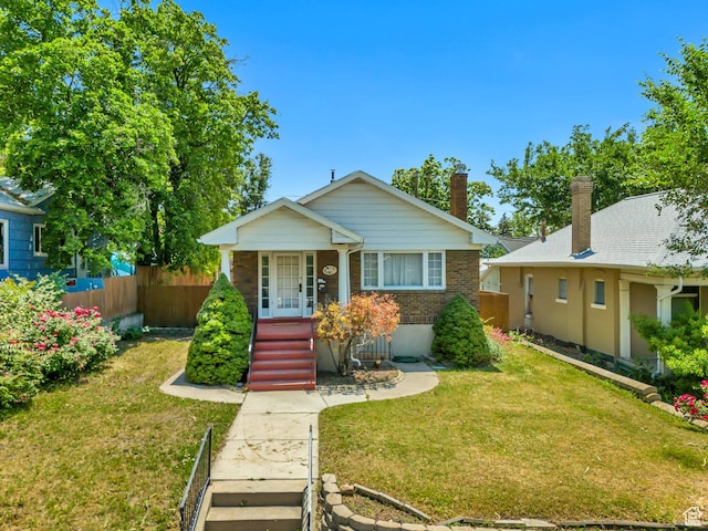 1252 E Bryan Ave S, Salt Lake City, UT 84105 - bungalow-style house with a porch, brick siding, and a chimney