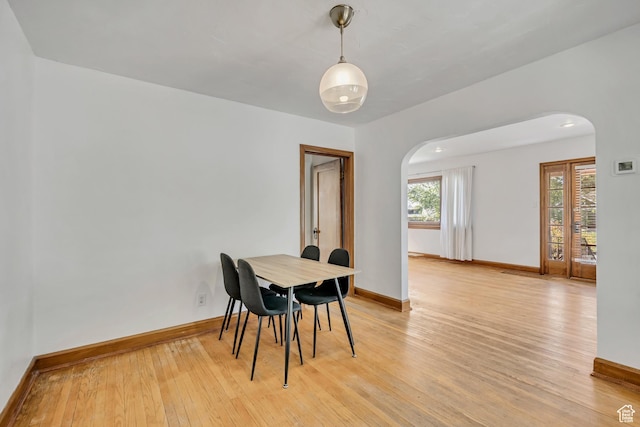1252 E Bryan Ave S, Salt Lake City, UT 84105 - dining area featuring arched walkways and light wood-style flooring