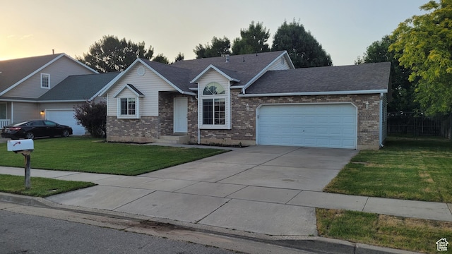 2826 W 4275 S, Roy, UT 84067 - ranch-style home with a garage, concrete driveway, a lawn, and brick siding