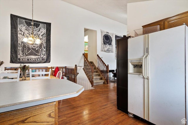 2826 W 4275 S, Roy, UT 84067 - kitchen with white fridge with ice dispenser, a chandelier, wood finished floors, and decorative light fixtures