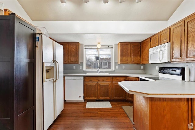 2826 W 4275 S, Roy, UT 84067 - kitchen with white appliances, dark wood finished floors, brown cabinetry, and light countertops
