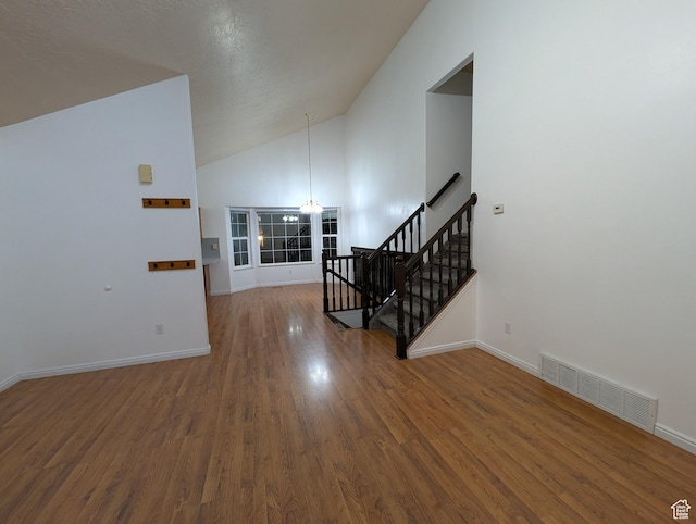 2826 W 4275 S, Roy, UT 84067 - staircase featuring a chandelier, wood finished floors, and high vaulted ceiling