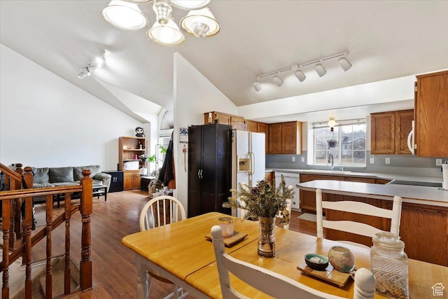 2826 W 4275 S, Roy, UT 84067 - dining space with rail lighting, wood finished floors, vaulted ceiling, and a chandelier